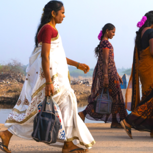 Women workers return home after a day of hard labour at leather factories in Ambur in Tamil Nadu, India